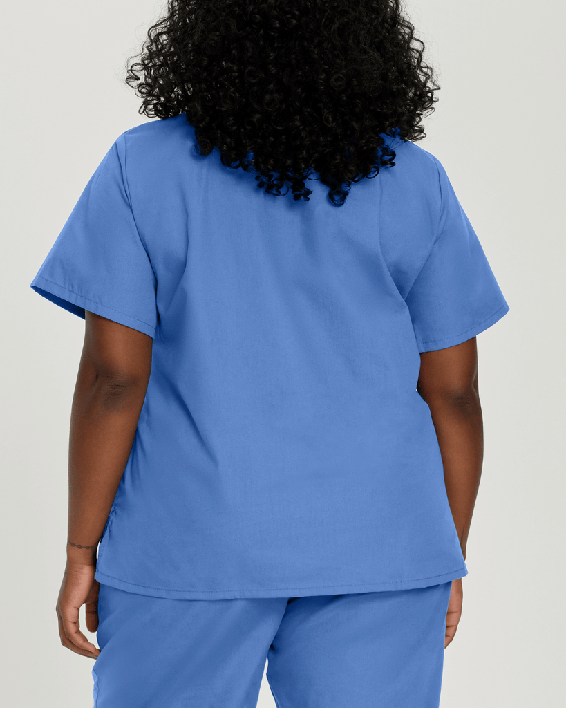 Woman in large sized ceil blue essentials by landau scrubs